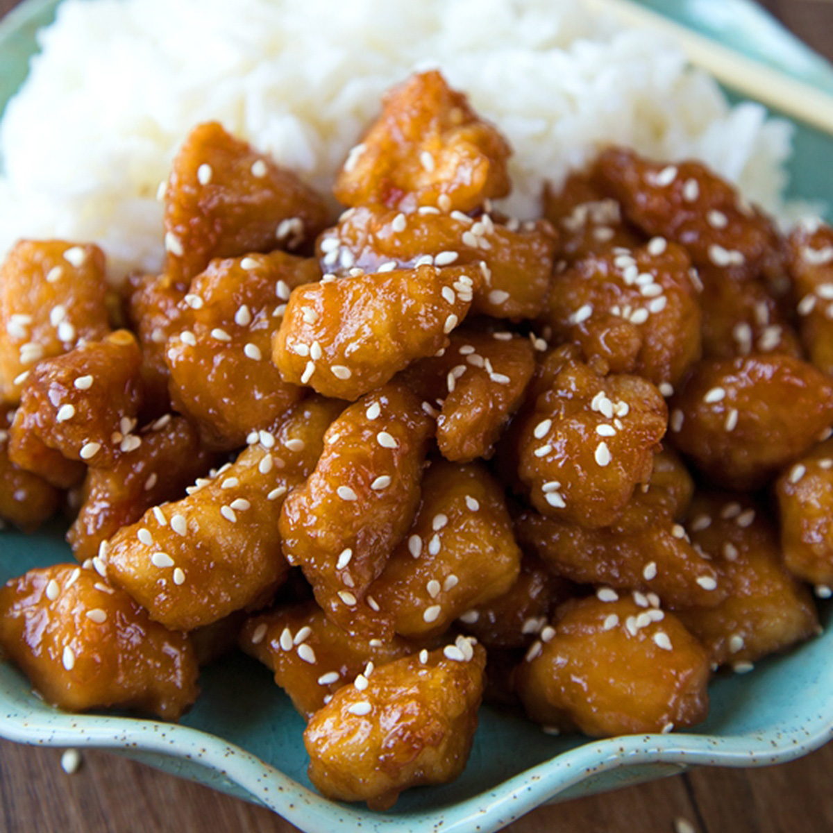 Sesame chicken with a glossy sauce and sesame seeds